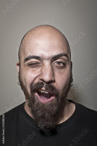 Man with beard winks