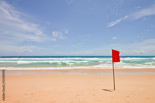 Red flag and sunny beach