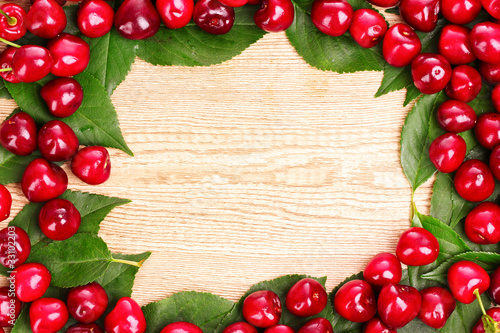 cherries frame on wooden background