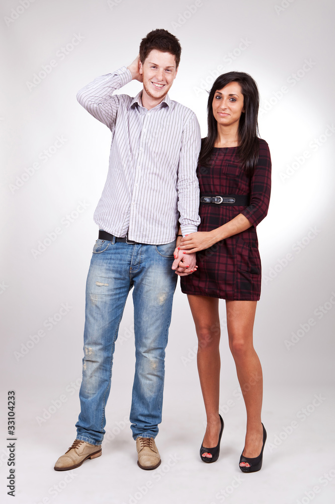 couple standing next to each other holding hands couple standing next to each other holding hands