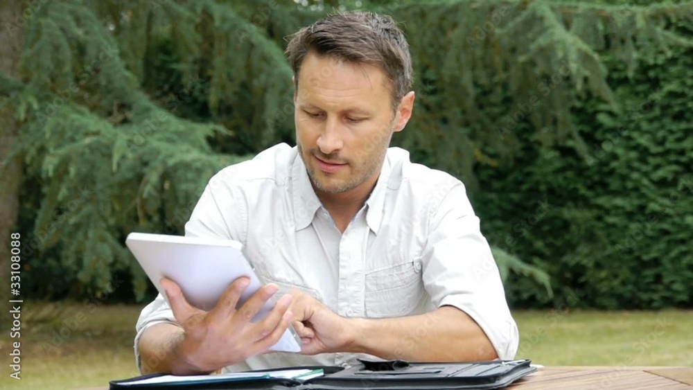 Man working with electronic tablet at home Man working with electronic tablet at home
