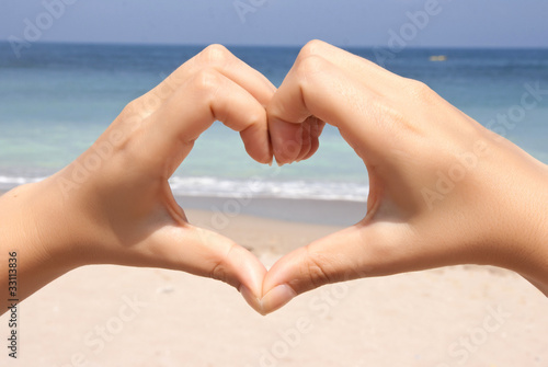 Heart fingers on beach
