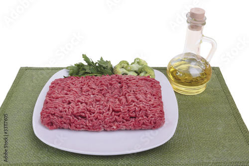 Raw ground beef with the ingredients. Isolated on white