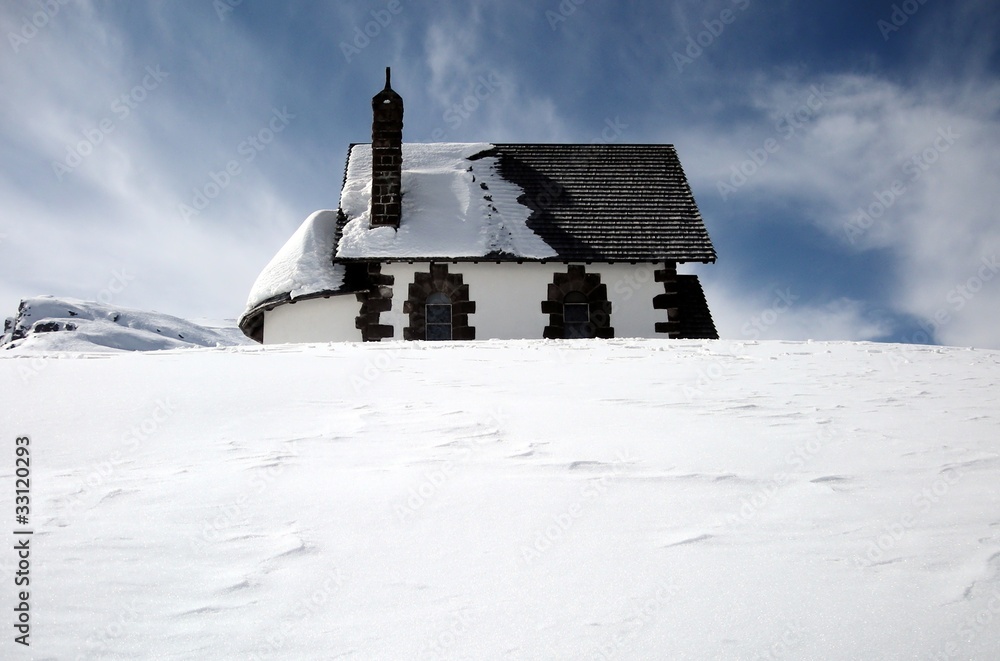 Isolated cottage in snow covered landscape
