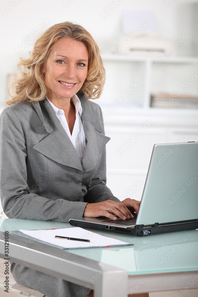 Female executive at laptop computer Female executive at laptop computer