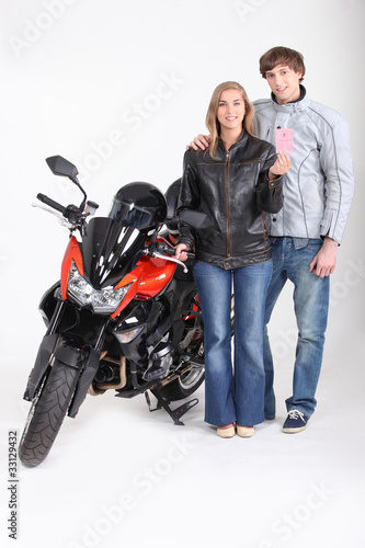 Young biker with driving licence photo