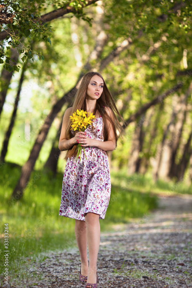 portrait of a beautiful blonde woman with yellow flowers outdoor portrait of a beautiful blonde woman with yellow flowers outdoor