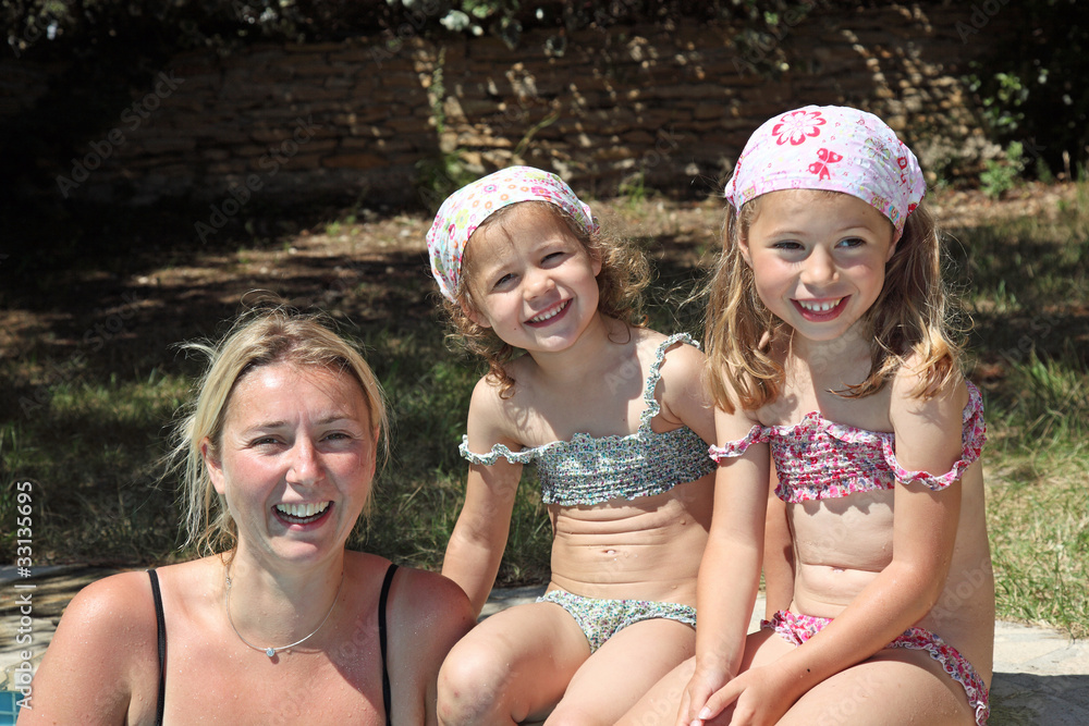 Mère et filles en maillot de bain à la piscine