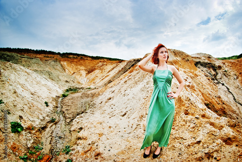 Young redhead woman in desert