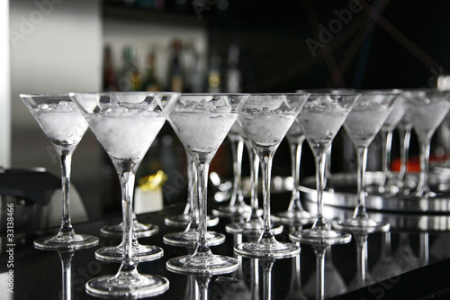 Classical martini in chilled glass over black background on