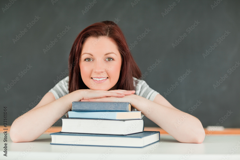 Young student with the chin on her books Young student with the chin on her books