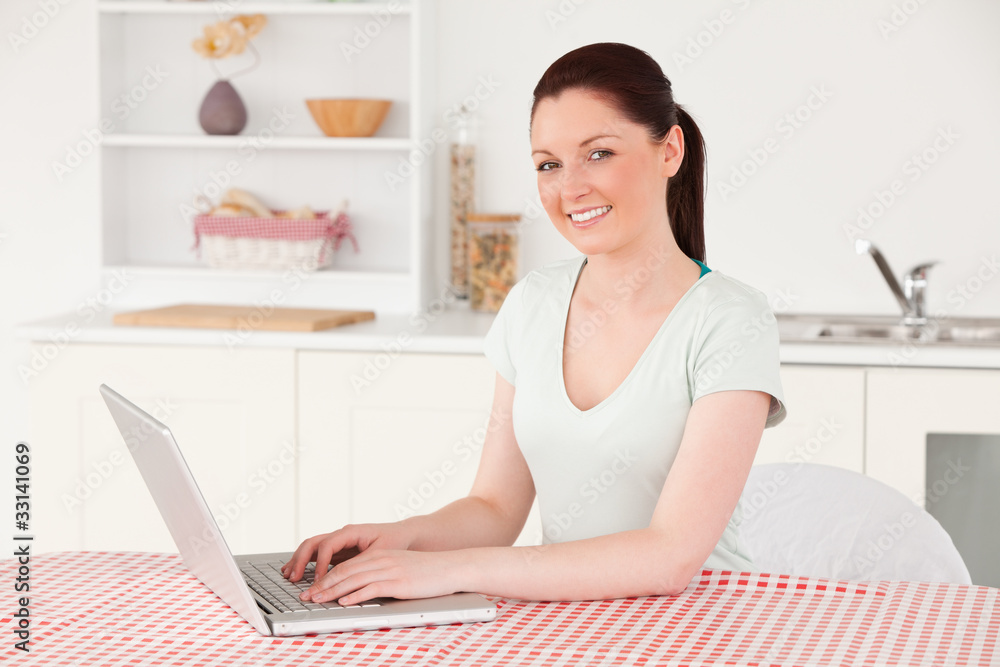 Beautiful woman posing while relaxing with her laptop at lunch t Beautiful woman posing while relaxing with her laptop at lunch t