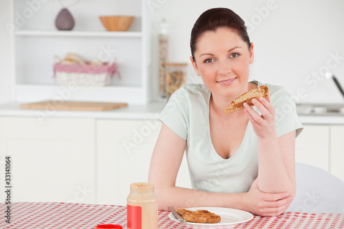 Beautiful woman posing while eating a slice of bread