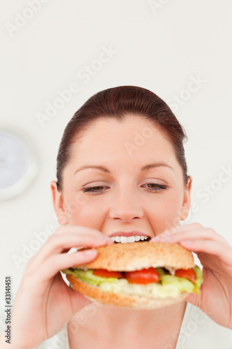 Cute woman eating a sandwich for lunch