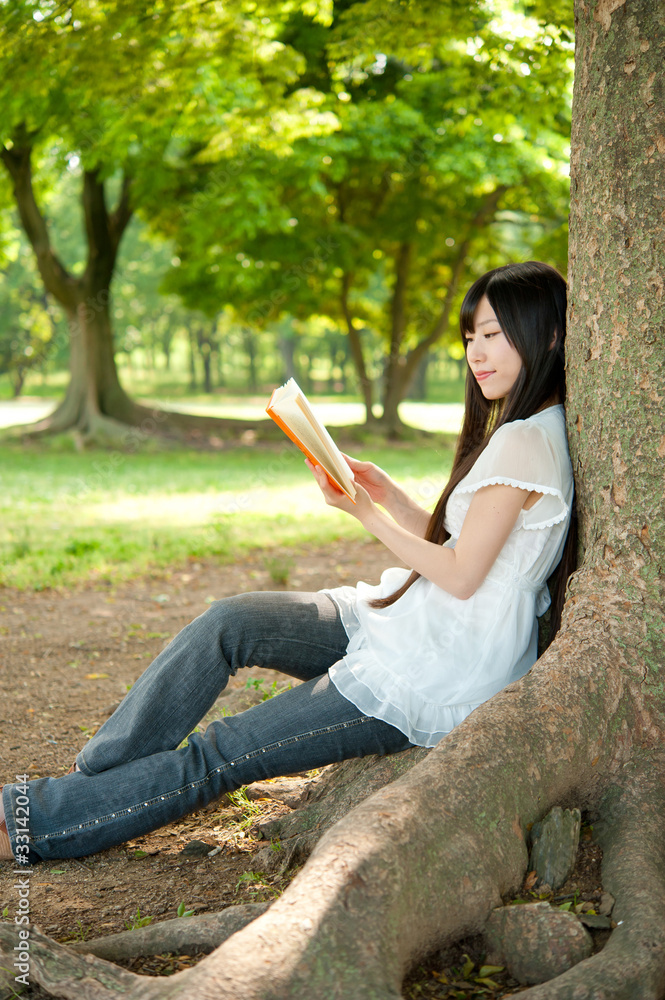 beautiful asian woman reading a book in the park beautiful asian woman reading a book in the park