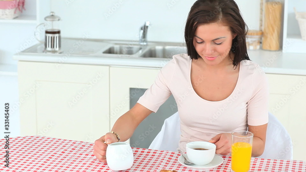 Young beautiful woman posing while having her breakfast Young beautiful woman posing while having her breakfast