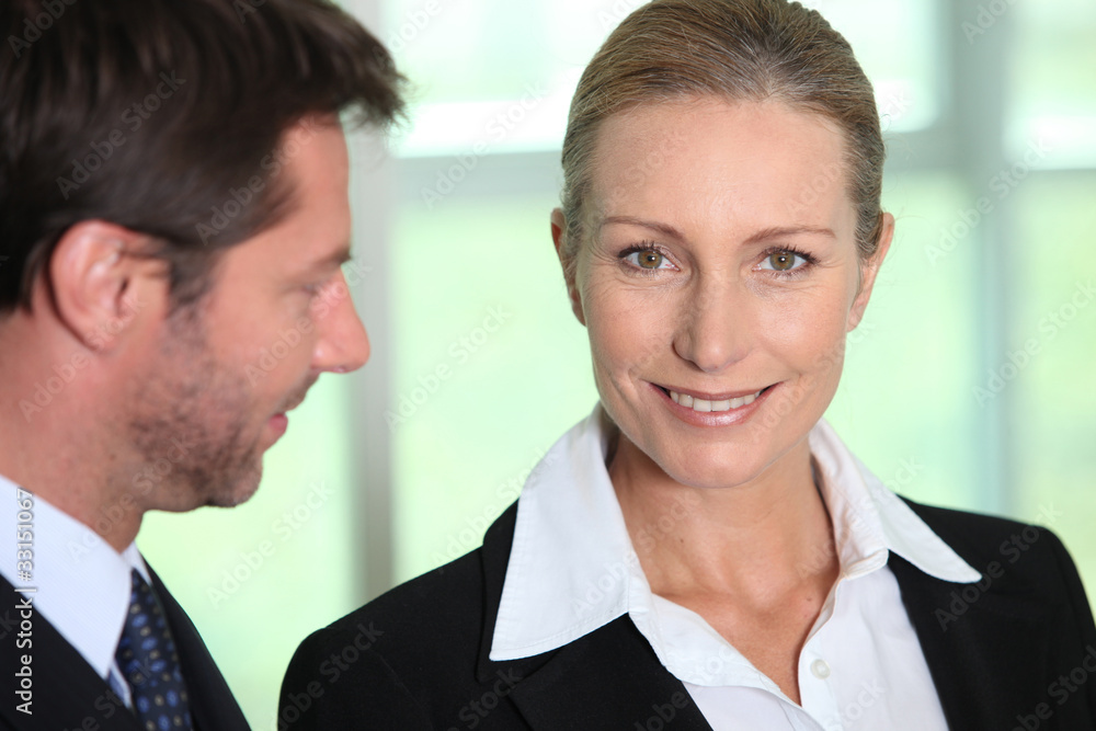 Businessman looking at businesswoman Businessman looking at businesswoman