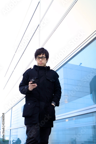 Business man using cellphone when waiting in station.