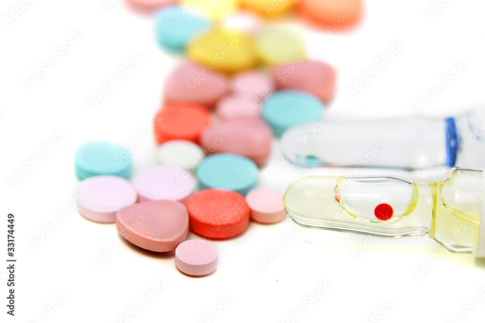 Colorful tablets and injection bottles on white background Colorful tablets and injection bottles on white background