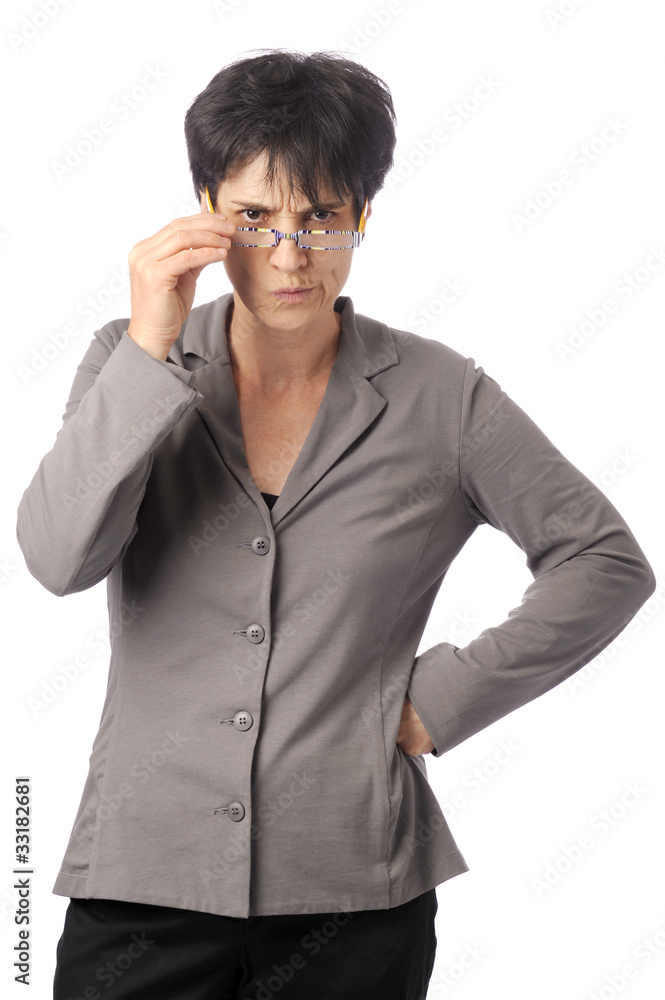 Displeased business woman looking over her glasses Displeased business woman looking over her glasses