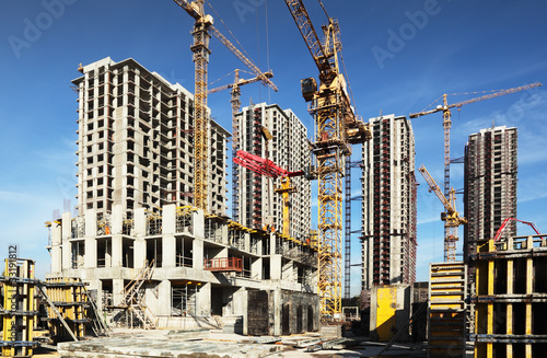 Inside place for tall buildings under construction and cranes