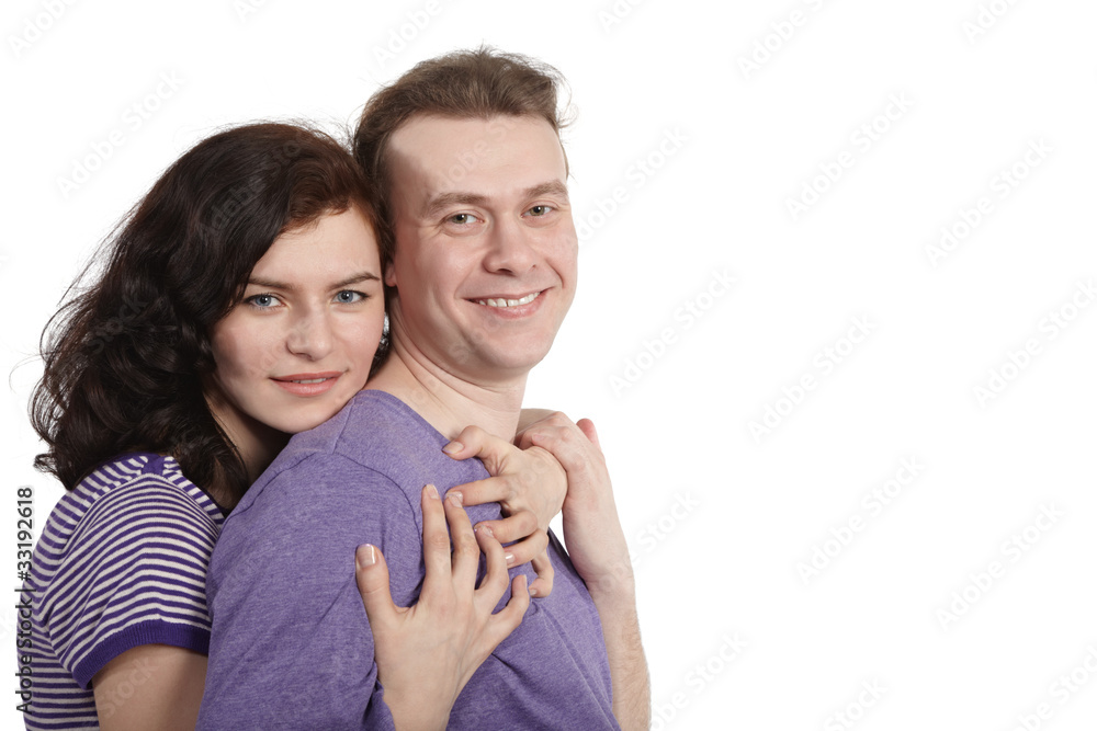 Young woman embraces a young man from behind. Young woman embraces a young man from behind.