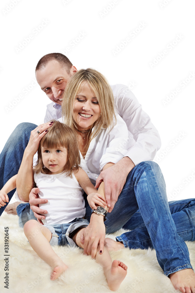 Mother, father and little daughter in white shirts and jeans