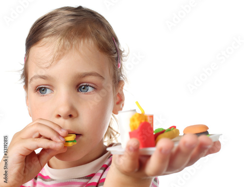 little girl eating toy miniature burger photo