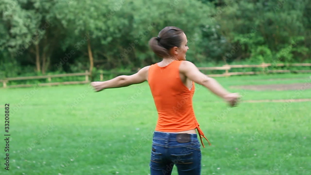 Happy woman turning around on meadow, slow motion, steadicam Happy woman turning around on meadow, slow motion, steadicam