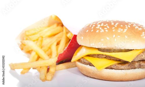 cheeseburger and a box of french fries isolated on white