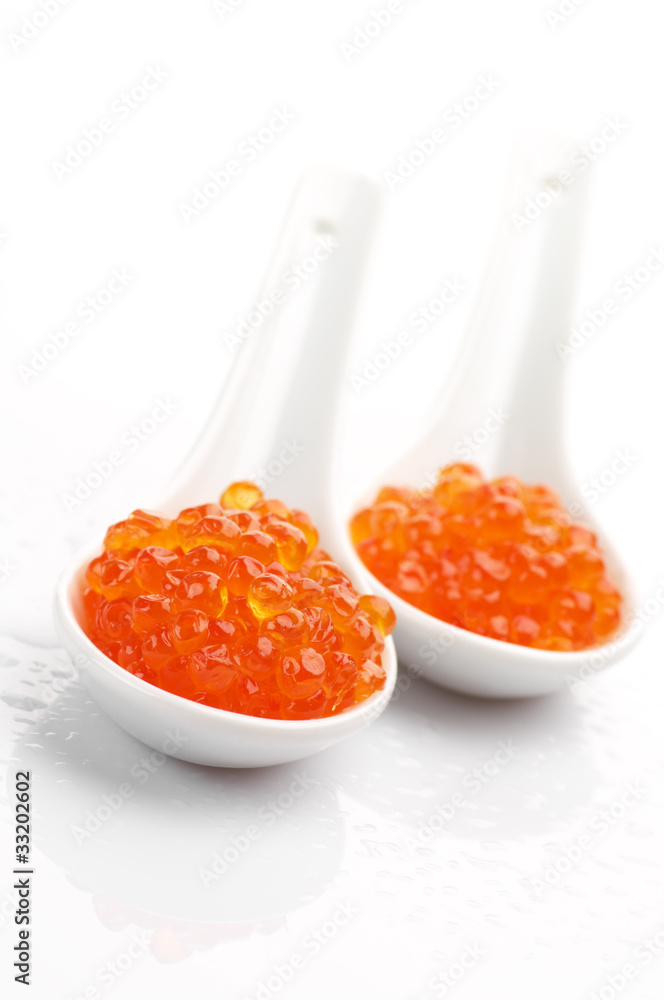 Salmon caviar in spoons Salmon caviar in spoons