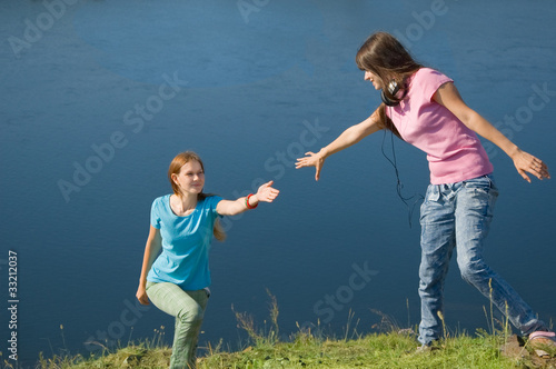 A girl helps her friend up photo