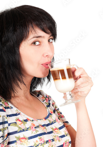 Beautiful brunette woman drinks cappuccino