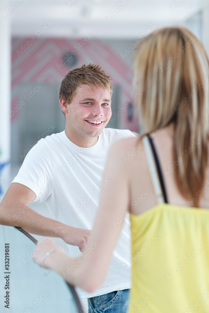 two college students talking/flirting on campus two college students talking/flirting on campus