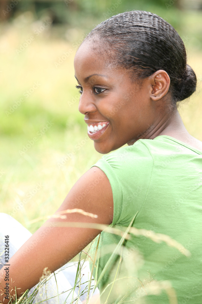 African woman sitting in the grass African woman sitting in the grass