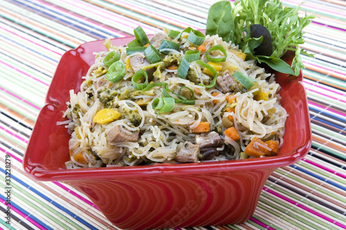 Pancit in a red ceramic dish photo