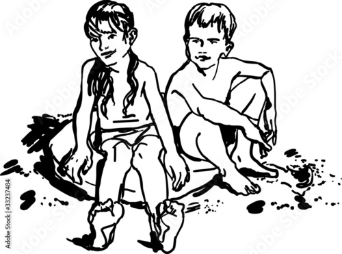 children boy and girl sitting on the beach