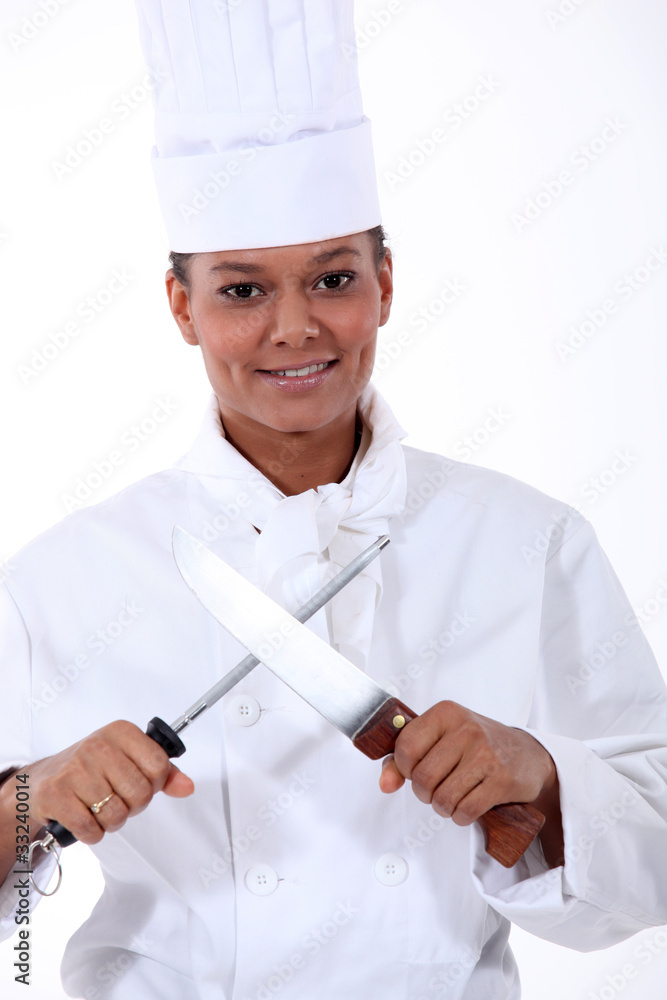 Chef sharpening a kitchen knife with a steel Chef sharpening a kitchen knife with a steel
