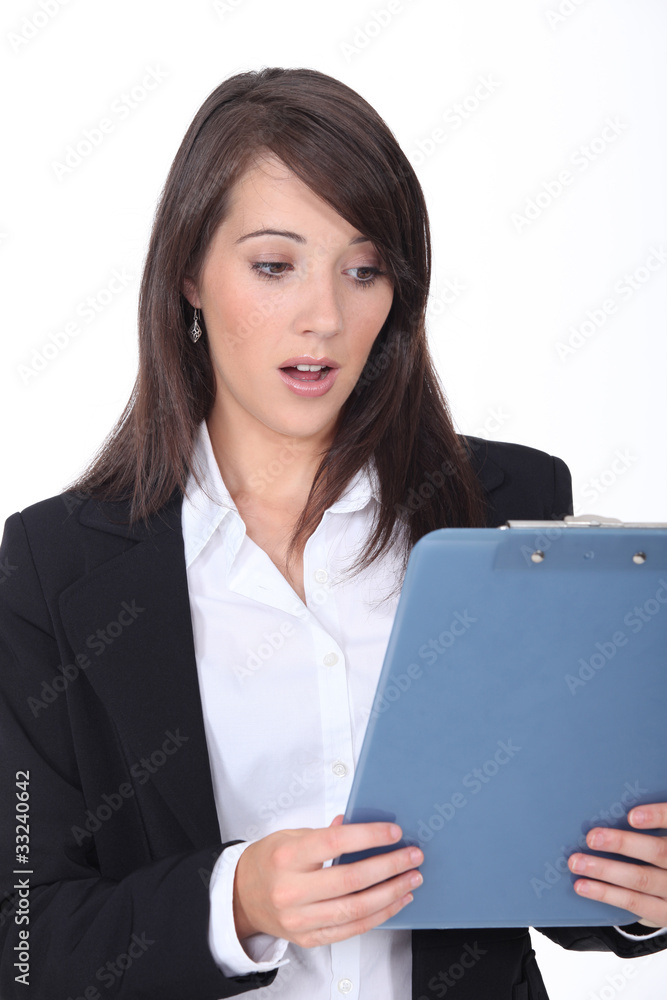Young woman surprised at her clipboard Young woman surprised at her clipboard