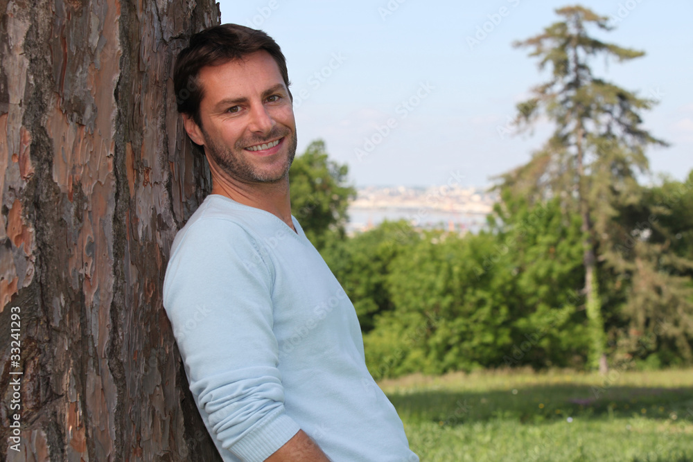 Man leaning against a tree Man leaning against a tree