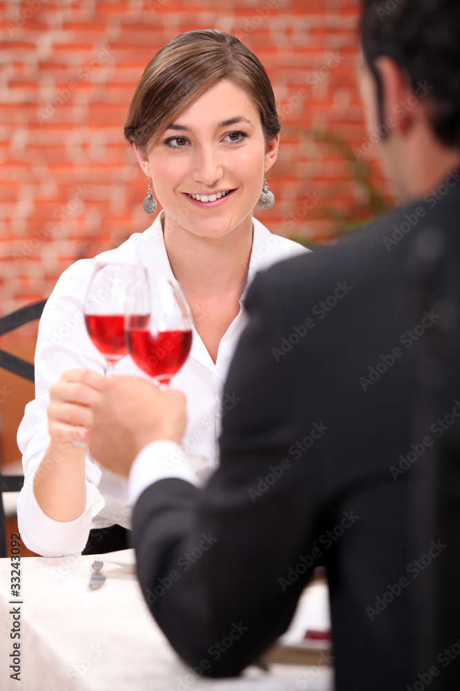 Couple drinking rose wine in a restaurant Couple drinking rose wine in a restaurant