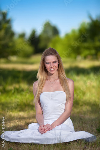 Beautiful young blonde woman in park
