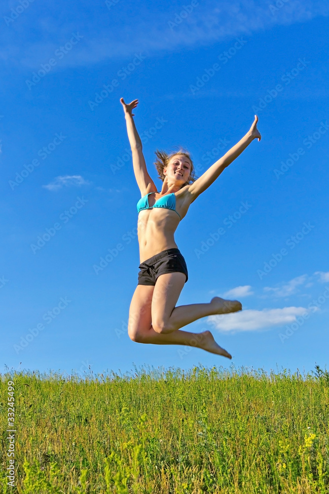 beautiful girl jumping against the blue sky beautiful girl jumping against the blue sky