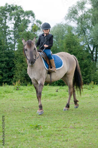 Horse riding - little girl is riding a horse