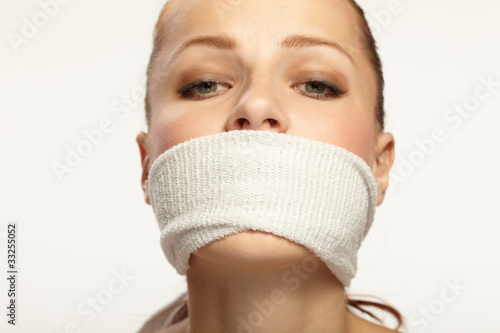 Cute young woman with white band on the mouth