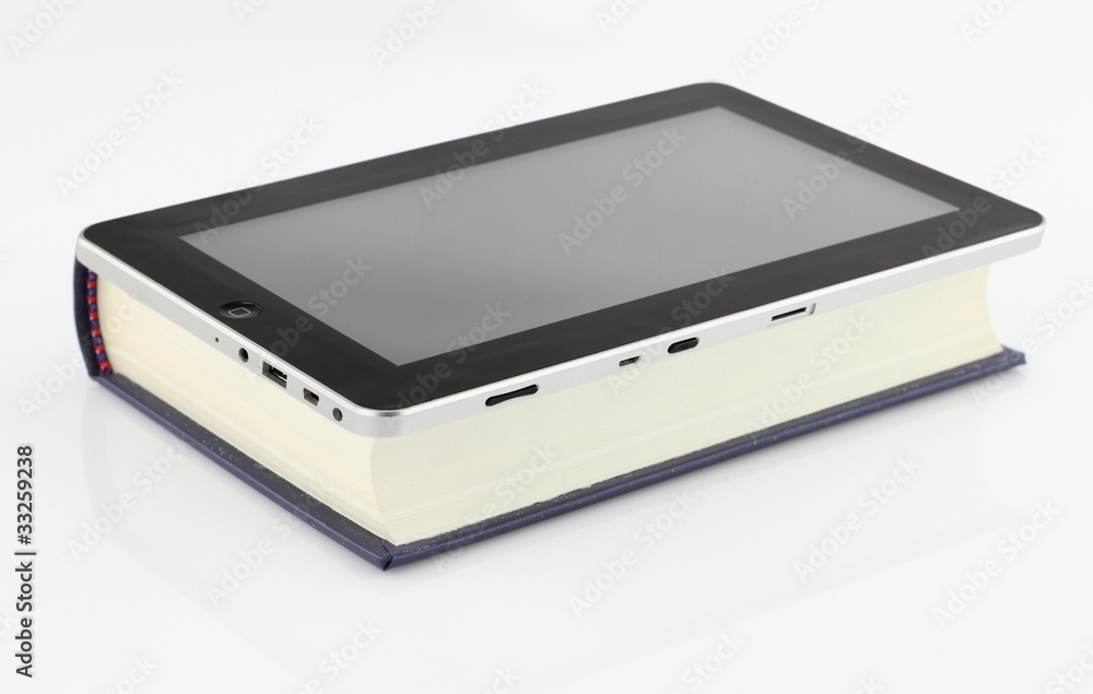 Tablet computer on book isolated on white Tablet computer on book isolated on white
