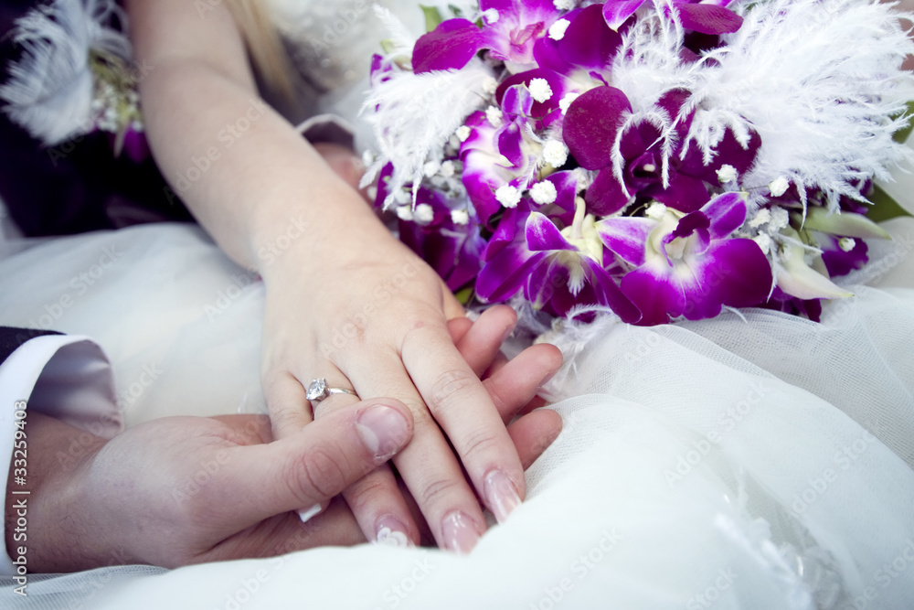 Fototapeta premium Hands and rings on wedding bouquet