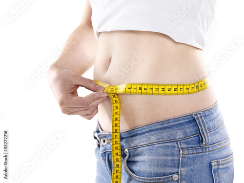 young woman measuring her waist