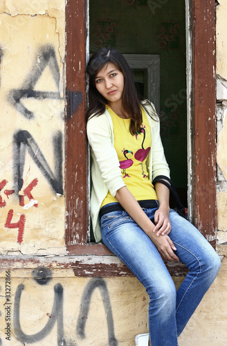 Girl sits on the window sill