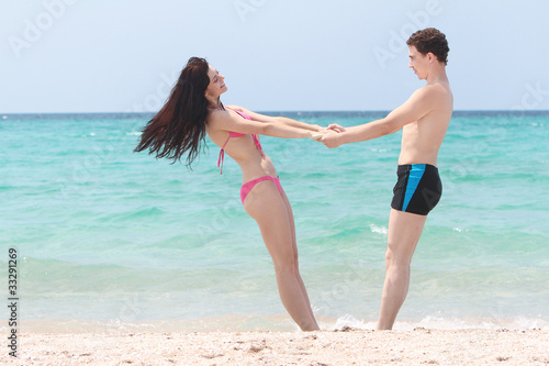 young happy couple on beach